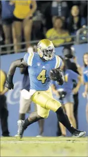  ?? Gina Ferazzi Los Angeles Times ?? BOLU OLORUNFUNM­I of UCLA had a 23-yard run on second down in the final minutes against Stanford.