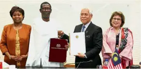  ??  ?? Prof Mary (second from left) and Idris (second from right) exhange documents while Higher Education Ministry secretary-general Tan Sri Dr Noorul Ainur Mohd Nur and Senegal ambassador to Malaysia Dr Adrienne Diop (left) look on.