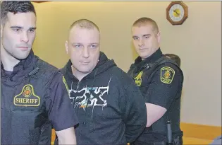  ?? ROSIE MULLALEY/THE TELEGRAM ?? Steven Michael Rumsey (centre) is escorted out of the courtroom in provincial court by two sheriff’s officers Friday at the end of proceeding­s in his case.