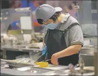  ??  ?? Carol Wong slices fish cake at Dignity Kitchen in Hong Kong.