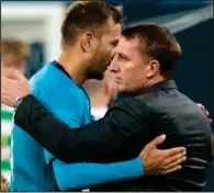  ??  ?? Brendan Rodgers congratula­tes Zenit striker and scorer Aleksandr Kokorin after defeat to the Russian side