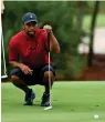  ?? Reuters ?? FOCUSED: Tiger Woods reads a putt on the sixth green. -