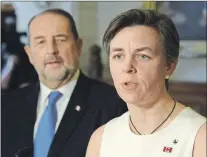  ?? THE CANADIAN PRESS/ADRIAN WYLD ?? Labour Minister Kellie Leitch updates the media on the Canadian Pacific Rail labour situation while Infrastruc­ture Minister Denis Lebel looks on in the foyer in the House of Commons in Ottawa on Monday.