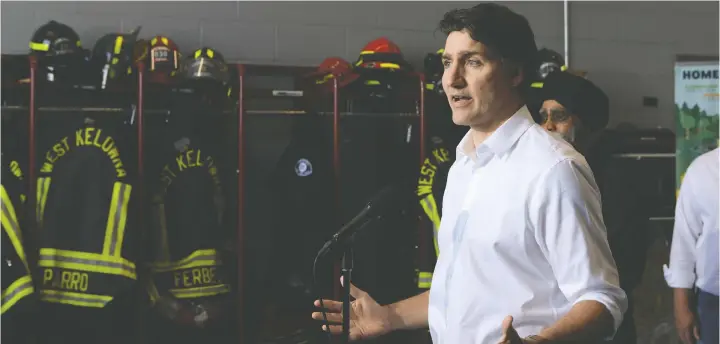  ?? — AARON HEMENS/THE CANADIAN PRESS ?? Prime Minister Justin Trudeau speaks about the upcoming wildfire season at the West Kelowna Fire Rescue hall in West Kelowna on Friday.