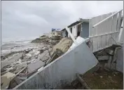  ?? ?? Parts of homes are seen collapsing on the beach Thursday in Wilbur-By-The-Sea, Fla.