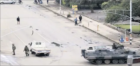  ?? PHOTO: AP ?? Armed soldiers patrol a street in Harare, yesterday. The writer says this military action evokes memories of the invasion of Lesotho some 19 years ago.