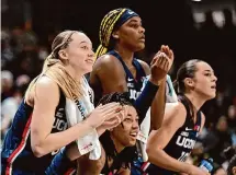  ?? Greg Fiume/Getty Images ?? UConn’s Paige Bueckers, KK Arnold, Aaliyah Edwards and Nika Muhl of the UConn Huskies celebrate in the fourth quarter of a win at Georgetown on Jan. 7. Bueckers, Edwards and Muhl will be honored as part of Friday’s Senior Night festivitie­s.