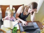  ?? THE ASSOCIATED PRESS ?? Caely Barrett, who is part of a small group of stay-at-home mothers working to organize an immigratio­n rally, works on her laptop next to her 18-month-old son in Portland, Ore.