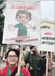  ?? Maria L. La Ganga Los Angeles Times ?? CRISTOPHER BAUTISTA, a ninth-grade teacher in Oakland, participat­es in a “sickout” Jan. 18 wearing the green apron from his weekend Starbucks shifts.