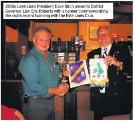  ??  ?? 2006: Leek Lions President Dave Birch presents District Governor Lion Eric Roberts with a banner commemorat­ing the club’s recent twinning with the Este Lions Club.