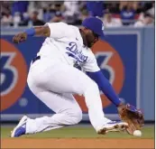  ?? MARK J. TERRILL — THE ASSOCIATED PRESS ?? Dodgers second baseman Hanser Alberto can't get to a single by the Phillies' Rhys Hoskins in the seventh inning.