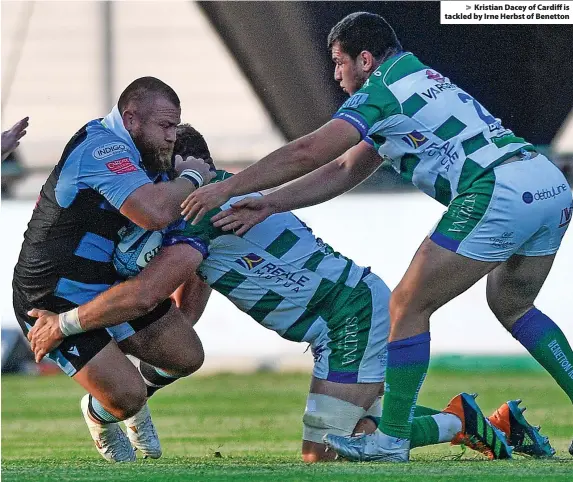  ?? ?? Kristian Dacey of Cardiff is tackled by Irne Herbst of Benetton