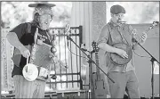  ?? AP/The Herald-Palladium/DON CAMPBELL ?? Daniel Daniel (left) and Alan Selvidge, members of the Deep Fried Pickle Project, perform Wednesday as part of the Brown Bag Concert Series at the John E.N. Howard Bandshell in downtown St. Joseph, Mich.