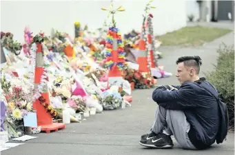  ??  ?? A STUDENT pays his respects outside the Masjid Al Noor mosque in Christchur­ch, New Zealand, yesterday. A steady stream of mourners paid tribute at a makeshift memorial to the 50 people slain by a gunman at two mosques. | VINCENT YU AP African News Agency (ANA)