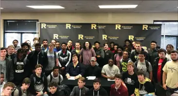  ?? Contribute­d photo by Dena Lumpkin ?? Cade Holder, Ridge Blackwell and Jay Hinkle are surrounded by teammates during a celebratio­n last week for National Signing Day 2018.