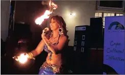  ??  ?? HOT STUFF: Mish Hendricks from Belly Phunk Oriental Dance Academy performs her innovative and spellbindi­ng fire routine.