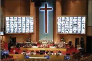  ?? LEE JIN-MAN - THE ASSOCIATED PRESS ?? Christians on the screen attend an online Christmas service for social distancing and a precaution against the coronaviru­s at the Yoido Full Gospel Church in Seoul, South Korea, Friday, Dec. 25.