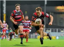  ?? PHOTO: PHOTOSPORT ?? Tim Bateman dots down for one of his three tries and Canterbury’s 11 in their demolition of Counties Manukau.