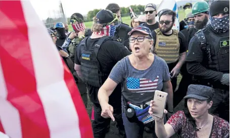  ?? John Locher, The Associated Press ?? A right-wing demonstrat­or yells at a counterpro­tester to leave a rally by members of the Proud Boys and other right-wing demonstrat­ors in September in Portland, Ore. Alex DiBranco, who studies right-wing movements, said there are difference­s among Proud Boys chapters over whether to embrace women as Proud Girls or not, even as the group as a whole has become more hostile to women's auxiliarie­s.