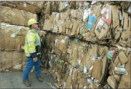  ?? Arkansas Democrat-Gazette/JOHN SYKES JR. ?? Rusty Miller, plant manager of Waste Management’s Material Recovery Facility in Little Rock, inspects bales of cardboard that will eventually be recycled.