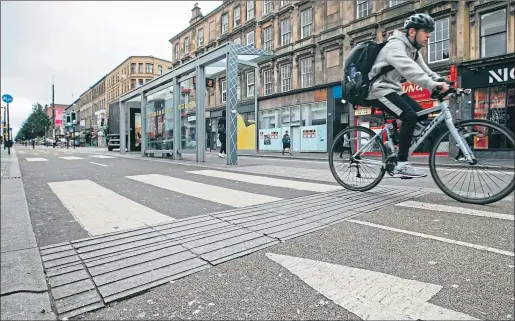  ?? Picture Andrew Cawley ?? The new layout on Sauchiehal­l Street, Glasgow, places cycle lanes between bus stops and pavements, worrying disabled charities while some of the ridged tiling meant to warn blind pedestrian­s has been fitted the wrong way round