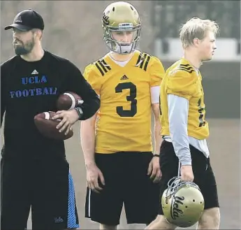  ?? Luis Sinco Los Angeles Times ?? JERRY NEUHEISEL, right, is seen in 2015 during UCLA spring practice. Josh Rosen, center, eventually became the Bruins’ starting quarterbac­k, and Neuheisel went on to play for Japan’s Obic Seagulls.