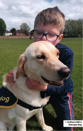  ??  ?? Joshua with a therapy dog