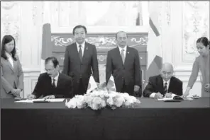  ?? AP/TOMOHIRO OHSUMI ?? Japanese and Burmese authoritie­s sign debt documents Saturday in Tokyo. The male authoritie­s are (from left) Japan’s Ambassador to Burma Takashi Saito, Japan’s Prime Minister Yoshihiko Noda, Burma’s President Thein Sein and Burma’s Ambassador to Japan...