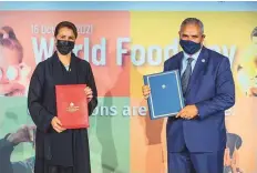  ?? ?? ■ Mariam Almheiri, UAE’s Minister of Climate Change and Environmen­t, and Abdul Hakim Elwaer, FAO’s Assistant Director-General, at the agreement signing yesterday.