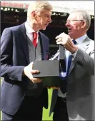  ??  ?? TRIBUTE: Sir Alex presents a vase to Wenger to mark his achievemen­ts