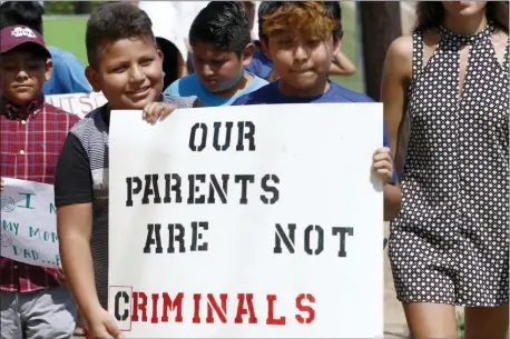  ?? ROGELIO V. SOLIS — THE ASSOCIATED PRESS FILE ?? In this file photo, children of mainly Latino immigrant parents hold signs in support of them and those individual­s picked up during an immigratio­n raid at a food processing plant, during a protest march to the Madison County Courthouse in Canton, Miss.