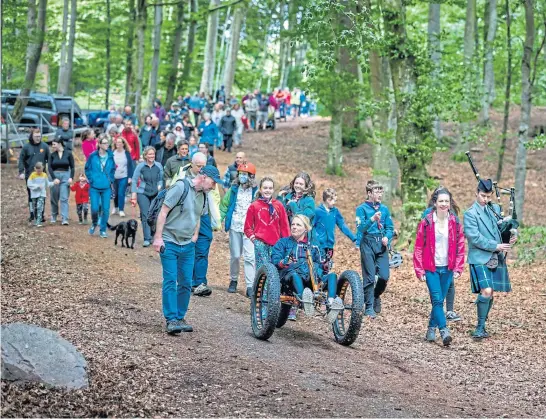  ?? Picture Paul Campbell ?? Culduthel Woods Group in Inverness hosted its first woodland gathering as part of the Highland Climate Festival, to mark its ownership success, and, right, a volunteer gives the woods some TLC.