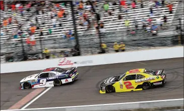  ?? BRIAN LAWDERMILK / GETTY IMAGES ?? William Byron, 19, takes the checkered flag just ahead of Paul Menard in the NASCAR Xfinity Series event Saturday and becomes the youngest winner of a major race on the Indianapol­is Motor Speedway oval.