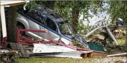  ?? ANDREW NELLES/THE TENNESSEAN VIA AP ?? Catastroph­ic flooding in middle Tennessee caused by record-shattering rainfall washed away homes and rural roads and wrecked cars and buildings in the Waverly area, leaving the area devastated while authoritie­s searched for missing people lost in the raging floodwater­s.