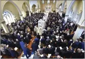  ?? TODD MCINTURF — DETROIT NEWS VIA AP ?? The casket of Brian Fraser proceeds into the church as family members, friends, and supporters gather at the funeral mass for Fraser at St. Paul on the Lake Catholic Church in Grosse Pointe Farms, Mich., on Saturday.