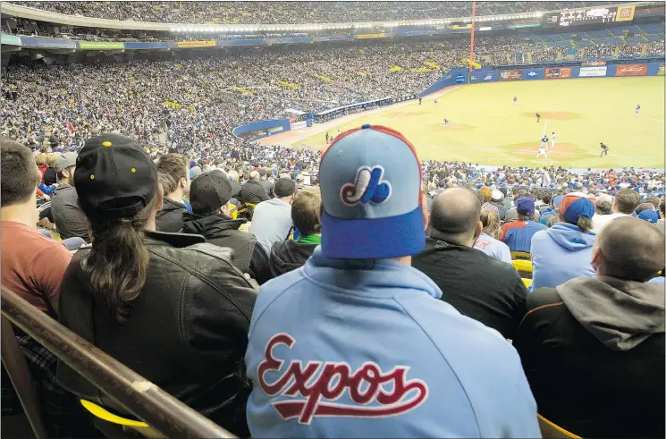  ?? — THE CANADIAN PRESS FILES ?? Fans wear Montreal Expos-branded clothing as they watch the Toronto Blue Jays in a pre-season baseball game against the New York Mets in 2014.