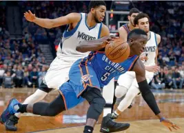  ?? — AP ?? Oklahoma City Thunder’s Victor Oladipo drives past Minnesota Timberwolv­es’ Karl-Anthony Towns (left) in their match.