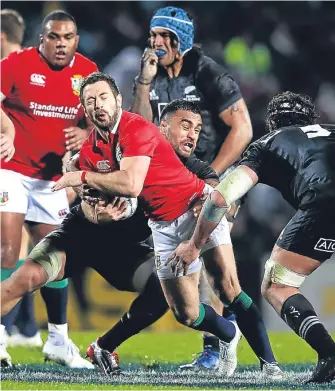  ??  ?? The Lions’ Scottish scrum-half, Greig Laidlaw, feels the force of the Maoris.