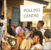  ?? PHOTO/ ?? Voters wait in line to cast their ballots during a presidenti­al, elections, outside a polling station in Freetown, Sierra Leone, on Wednesday. AP COOPER INVEEN