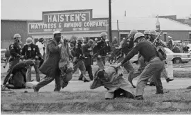  ?? Photograph: unknown/AP ?? On 7 March 1965, a state trooper swings a billy club at John Lewis, chairman of the Student Nonviolent Coordinati­ng Committee, during a civil rights voting march in Selma, Alabama.