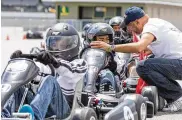  ?? CONTRIBUTE­D ?? Rod Reid, president and chief instructor of NXG Youth Motorsport­s, instructs a young go-kart driver. He’s co-hosting 50 Dayton kids Saturday at IMS.