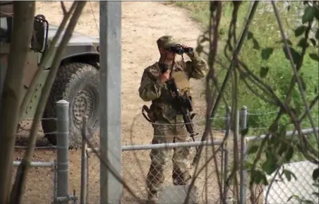  ?? JOHN MONE — THE ASSOCIATED PRESS FILE ?? A National Guard troop watches over Rio Grande River on the border in Roma, Texas. The deployment of National Guard members to the U.S.-Mexico border at President Donald Trump’s request was underway with a gradual ramp-up of troops under orders to help...