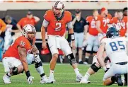  ?? [PHOTO BY NATE BILLINGS, THE OKLAHOMAN] ?? Oklahoma State offensive lineman Larry Williams (56) listens to quarterbac­k Mason Rudolph (2) call an audible during a 2017 game against Tulsa.