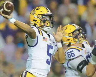  ?? JONATHAN BACHMAN/GETTY ?? LSU quarterbac­k Jayden Daniels accounted for 5 touchdowns during the Tigers’ 52-35 win on Saturday night at Tiger Stadium in Baton Rouge.