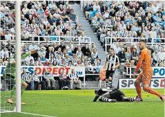  ??  ?? Self-inflicted: Chancel Mbemba scores an own goal to gift Wolves the lead