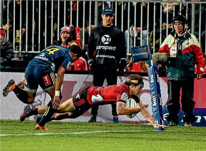  ?? PHOTOSPORT ?? George Bridge scores the Crusaders’ first try during their Super Rugby clash against the Highlander­s at the temporaril­y renamed Wyatt Crockett Stadium in Christchur­ch last night.