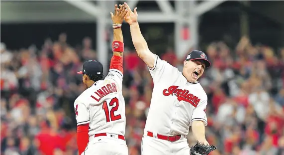  ?? JASON MILLER/GETTY IMAGES ?? Francisco Lindor and Jay Bruce celebrate the Indians’ 4-0 win over the New York Yankees Thursday in Cleveland.