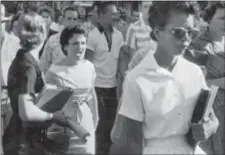  ?? WILL COUNTS — ARKANSAS DEMOCRAT-GAZETTE VIA AP, FILE ?? In this file photo, students of Central High School in Little Rock, Ark., including Hazel Bryan, shout insults at Elizabeth Eckford as she calmly walks toward a line of National Guardsmen. The Guardsmen blocked the main entrance and would not let her enter. Monday marks 60 years since the Little Rock Nine first entered the school for classes.