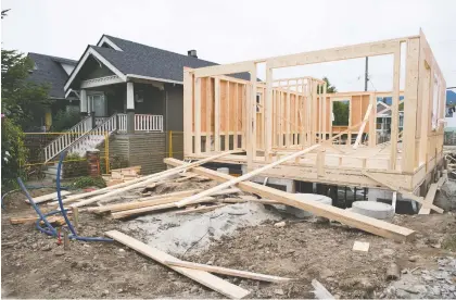  ?? JONATHAN HAYWARD/THE CANADIAN PRESS FILES ?? The CMHC has blamed the economic damage from COVID-19 for its bearish outlook on housing, which predicts housing starts could drop from 51 to 75 per cent and sales volumes could crumble between 19 and 29 per cent.