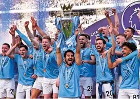  ?? ?? Manchester City captain Ilkay Gundogan lifts the trophy as his team-mates join him in celebratio­n at the presentati­on ceremony after their English Premier League match against Chelsea on Sunday (AFP)